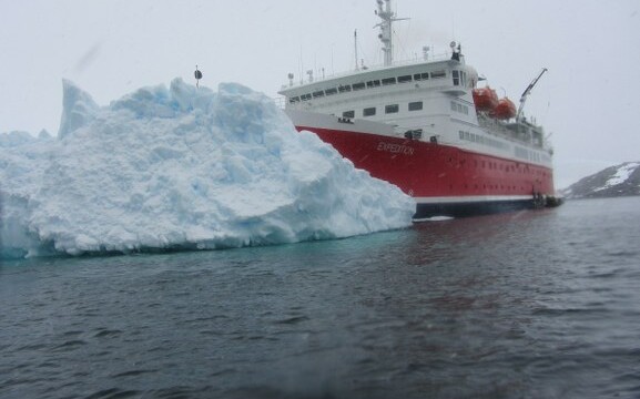 An iceberg surrounds the MS Expedition